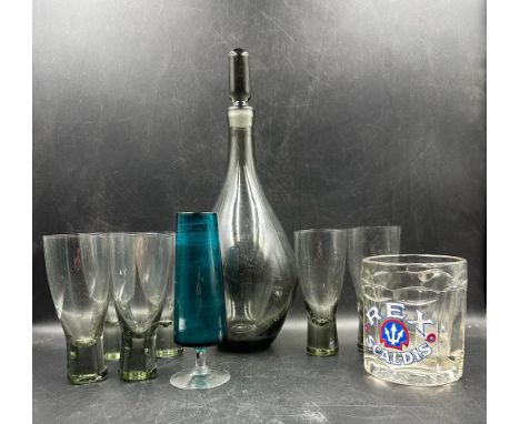 A selection of glassware to include a mid century grey smoked glass decanter and six matching glasses a blue tulip glass and 