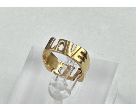 A 14ct gold ring, with Love and F*** on it, approximate total weight 3.9g and size K