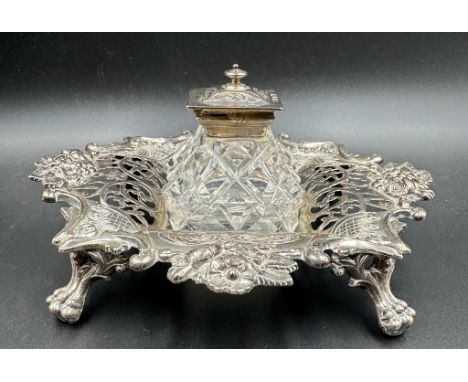 A Victorian cut glass and silver topped inkwell on a pierced silver stand with foliate decoration, hallmarked for Sheffield 1