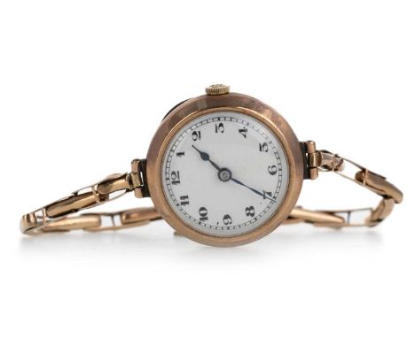 NINE CARAT GOLD CASED MANUAL WIND WRIST WATCH, the round dial with Arabic hour markers, 25mm case, on a nine carat gold expan