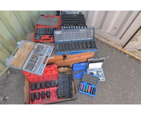 Mixture of garage equipment, drill bits, sockets and other tools. 