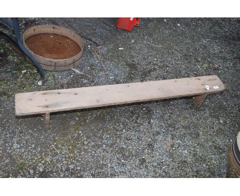 A small wooden bench, 54'' long x 7'' high.