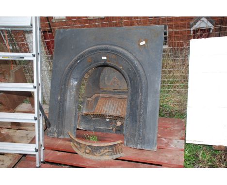 A cast iron fireplace and fire back, 38'' high x 38'' wide.