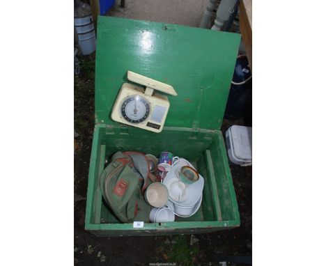A green painted box containing rucksack, crockery, weighing scales, etc.