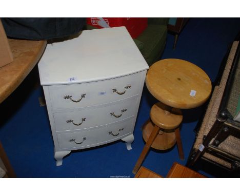 A white bedside chest of three drawers and an adjustable stool with screw pillar.