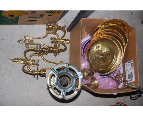 A Primus stove, wall lights, plates, candlesticks and horse bits.