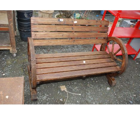 Wooden garden bench with wheel ends, 44'' wide x 29'' high.
