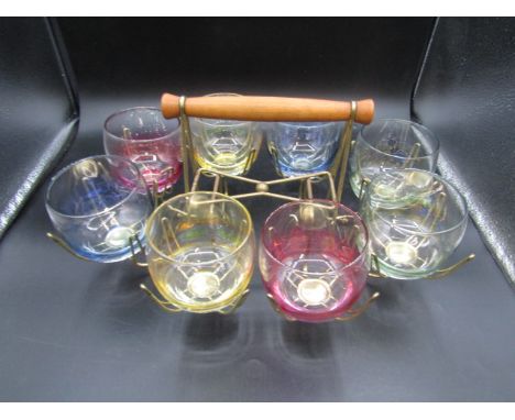retro lustre coloured glasses in brass caddy