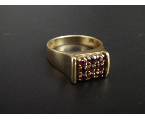 A hallmarked 9ct gold, garnet chessboard ring ( set with 9 garnets)&nbsp; size O. 5.9g total weight