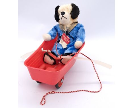 Chiltern dog in boat pull-along novelty, late 1950s-early 1960s; artificial silk dog in plastic boat on wheels with rowing mo