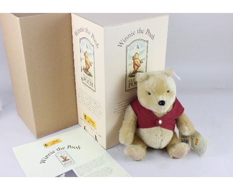 A Steiff limited edition mohair Winnie the Pooh, with ear button, 27cm high, boxed with paperwork