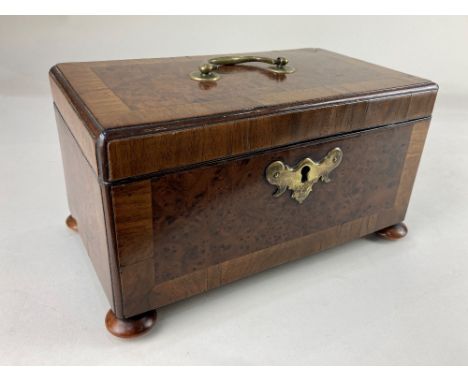 A George III burrwood and cross banded tea caddy, rectangular shape with brass handles and escutcheon, three section interior