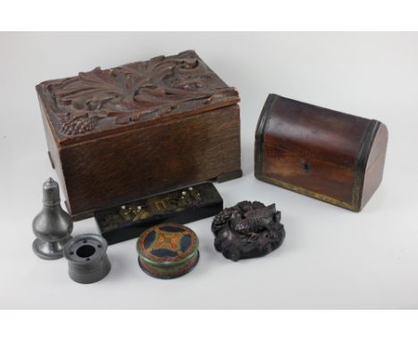 A carved oak box, the hinged lid with foliate decoration, 30cm, a brass bound desk tidy with domed pointed lid, 19cm, and a s