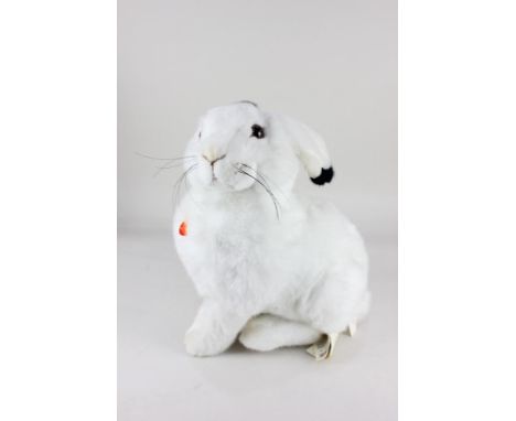 A Steiff white plush toy of Hoppel the snow hare, seated, with maker's tags and ear button, 40cm high
