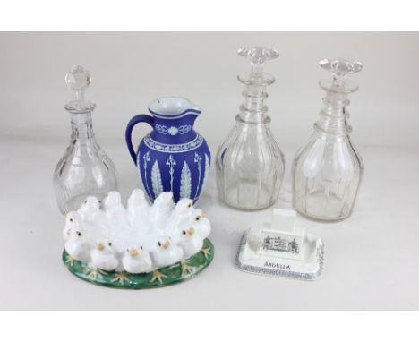 A 'Jasperware' blue and white porcelain jug, with foliate decoration (a/f), and three glass decanters, to include a pair of r