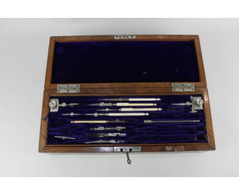 An Army and Navy part set of draughtsman's tools, in fitted rectangular brass bound walnut case, 37cm
