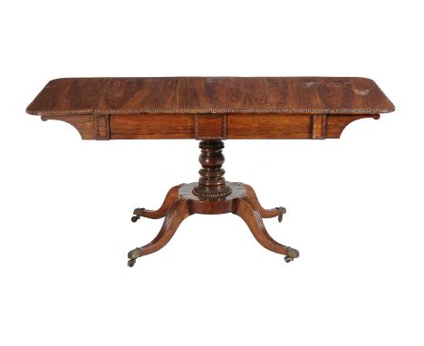 A Regency rosewood sofa table, circa 1815, in the manner of Gillows, the rectangular top with reeded edge, above a half friez