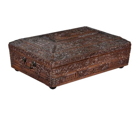 ϒAn Anglo Indian, probably Mysore, sandalwood sewing box, circa 1880, of rectangular form, relief carved with elaborate folia