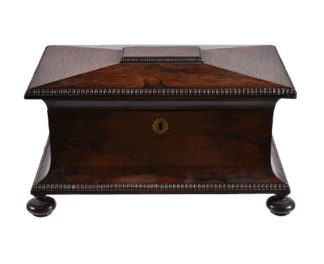 ϒA Regency rosewood tea caddy, circa 1820, in the manner of Gillows, the lid enclosing two lidded canisters and an associated