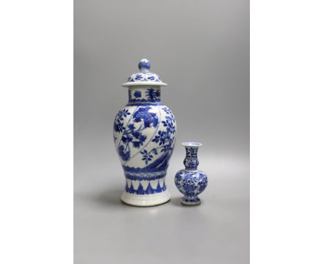 A Chinese blue and white vase and cover, Kangxi mark, 19th century, 26.5cm tall, and a Chinese Kangxi period small vase (2)