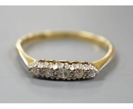 An 18ct and plat. five stone diamond set ring, size R, gross weight 2.4 grams.