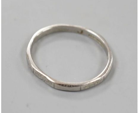 A white metal (stamped platinum) wedding band, size K,1.8 grams.