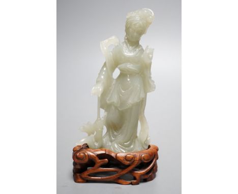 A Chinese celadon jade figure of a lady wood stand,13 cms high.