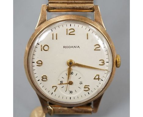 A gentleman's 9ct gold Rodania manual wind mid size wrist watch on associated gold plated expanding bracelet.