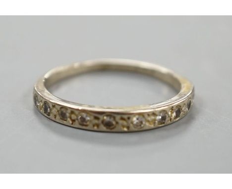 A white metal and diamond chip set half eternity ring, size K,gross 1.9 grams.