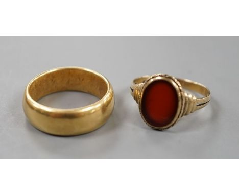 A George V 18ct gold wedding band, size Q, 14 grams and a 333 standard yellow metal and carnelian set signet ring, size R, gr