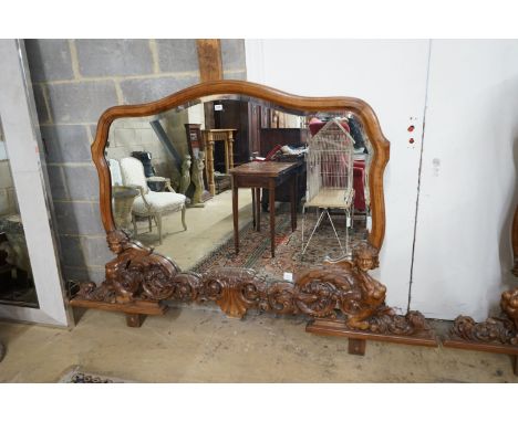 A near pair of Italian style carved walnut overmantel mirrors, decorated with winged figures, scrolls and scallop shells, lar