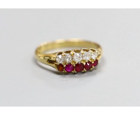 A late Victorian 18ct gold, graduated five stone ruby and five stone diamond set twin row ring, size O, gross 3 grams.