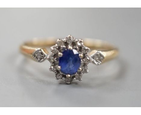 A modern 9ct gold, sapphire and diamond set cluster ring, size R, gross 2.3 grams.