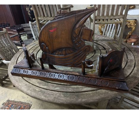An early 20th century carved oak fender, length 124cm and a firescreen
