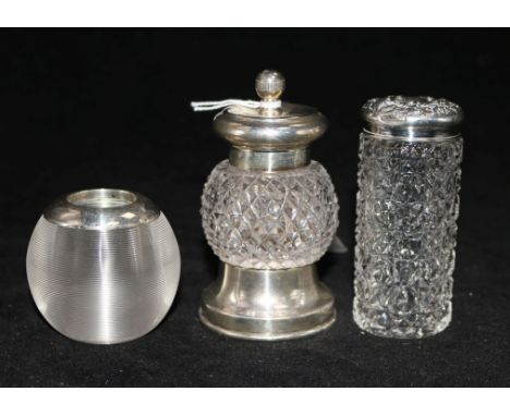 A silver mounted pepper grinder and silver mounted glass match striker and toilet jar.