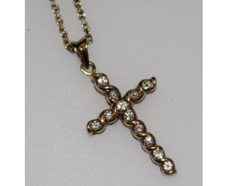 A 9ct gold and diamond set cross pendant on a 9ct gold chain, pendant 1in.