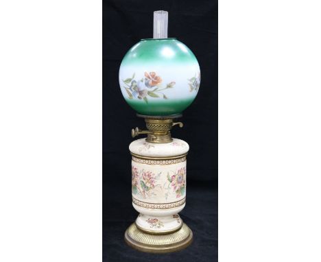 A ceramic based and floral glass shaded oil lamp
