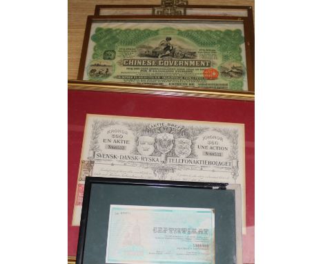 Two framed Chinese share certificates and a telephone certificate, and a Russian certificate