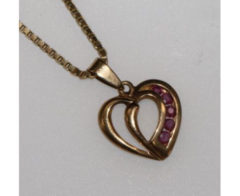 A 9ct gold and ruby set heart pendant on a 9ct gold chain.