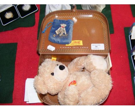 A modern Steiff teddy bear in suitcase together with metal articulated bear with pouch 