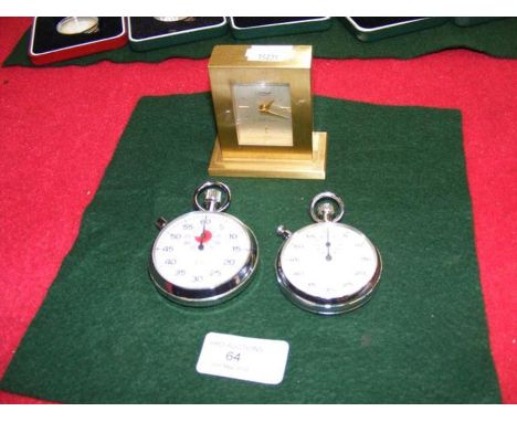 A Cartier bedside clock together with two stop watchesCONDITION REPORTIn our judgement, the bedside clock is not in ticking o