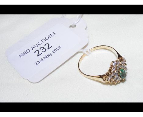 An emerald and diamond cluster ring in yellow metal setting (possibly 14ct)
