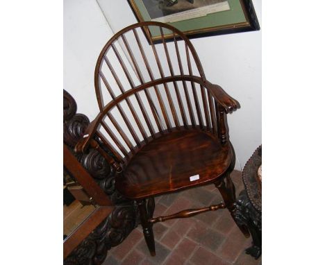 An antique stick-back country armchair 