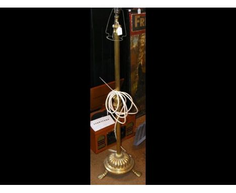 An adjustable antique brass standard lamp