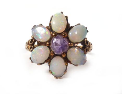 A 9ct yellow gold ring set centrally with a single amethyst and six opals within a flowerhead setting, ring size S, 2.7 gms