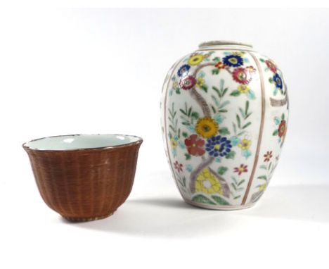 A late 19th century Japanese four panelled ginger jar and cover florally decorated with coloured enamels on a white ground, h