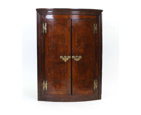 A George II pollard oak and crossbanded corner cabinet of bow fronted form, w. 70 cm   CONDITION REPORT:  Handles presumably 