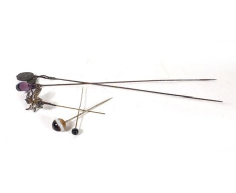 A silver mounted hat pin having an amethyst glass finial in the form of a golf club, maker C&S, Chester 1908, l. 25 cm, toget