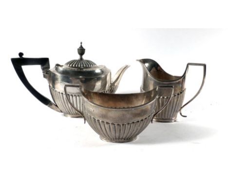 A late Victorian silver harlequin bachelors three piece tea service of vase shaped form having gadrooned decoration, makers J