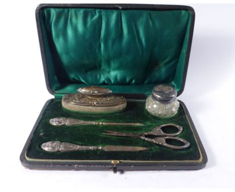 An early 20th century cased silver mounted five piece manicure set, each item repousse decorated with putti, maker HM, Birmin